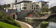 Image shows the Civic Centre with walking path around the Lagan lock