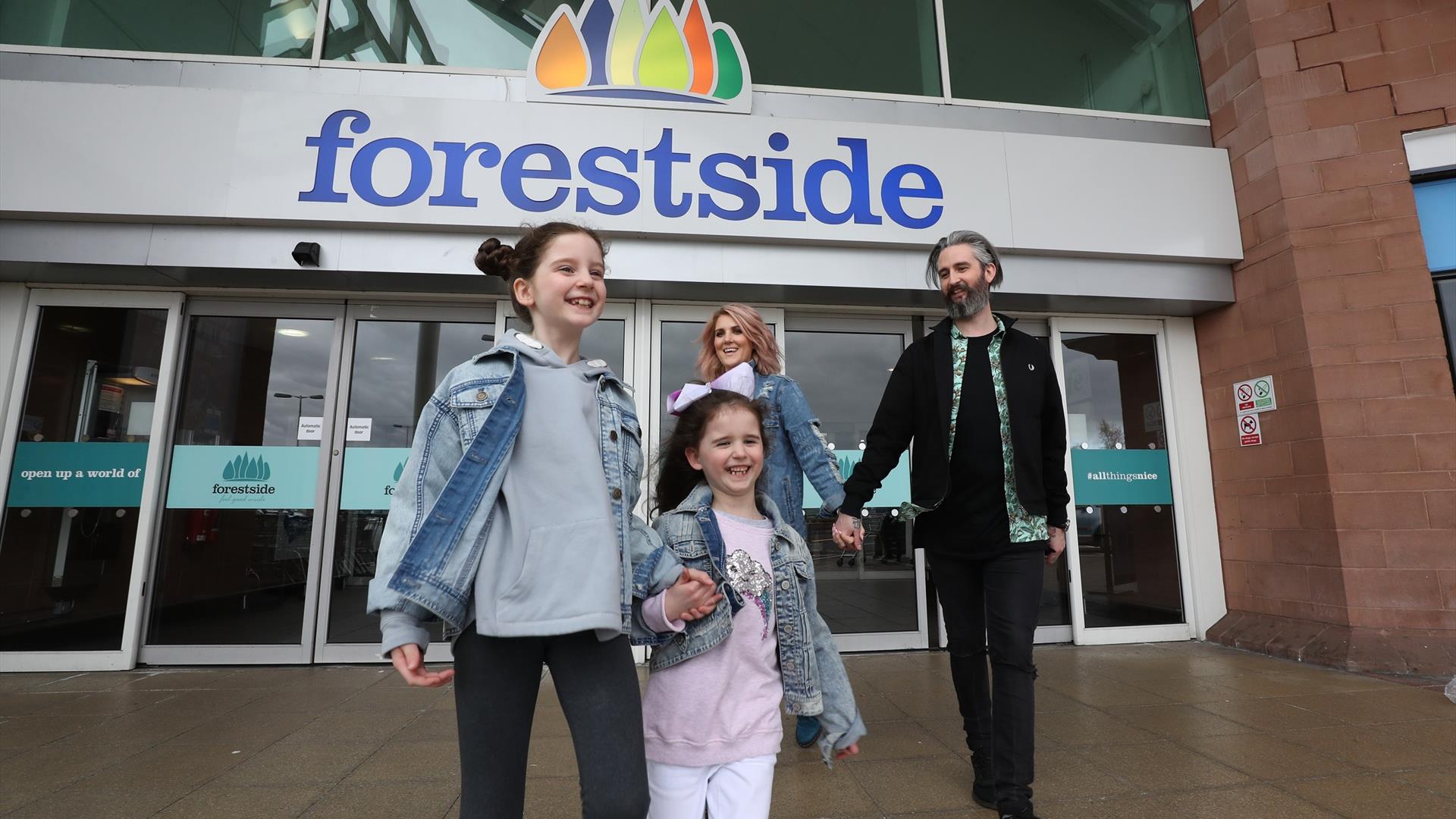 An image of a family leaving the shopping centre at Forestside