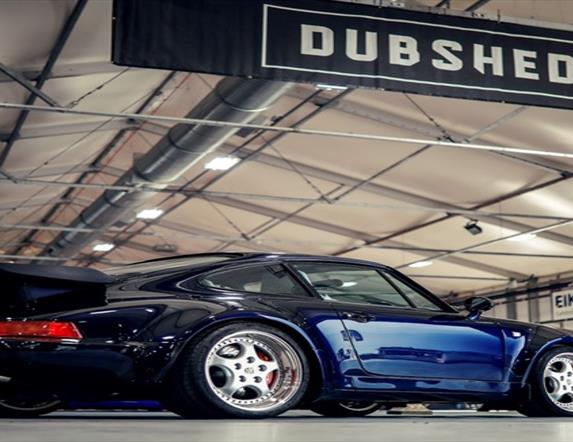 Dark Blue Car with Dubshed sign above it