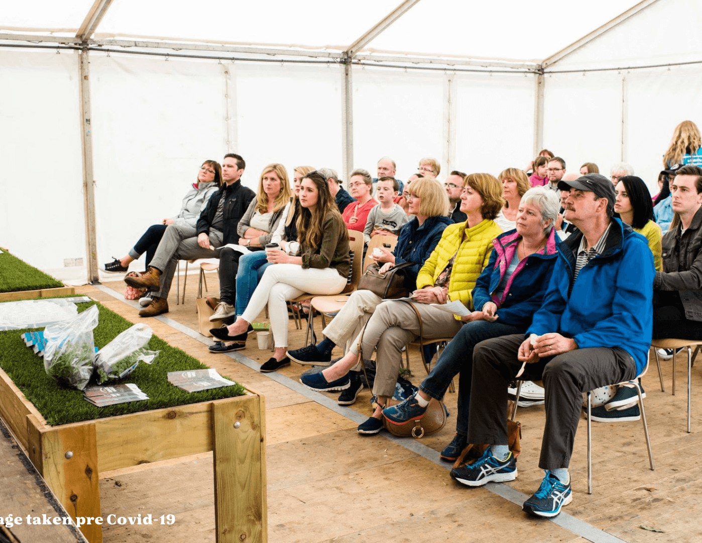 People sittnig watching a cooking demo