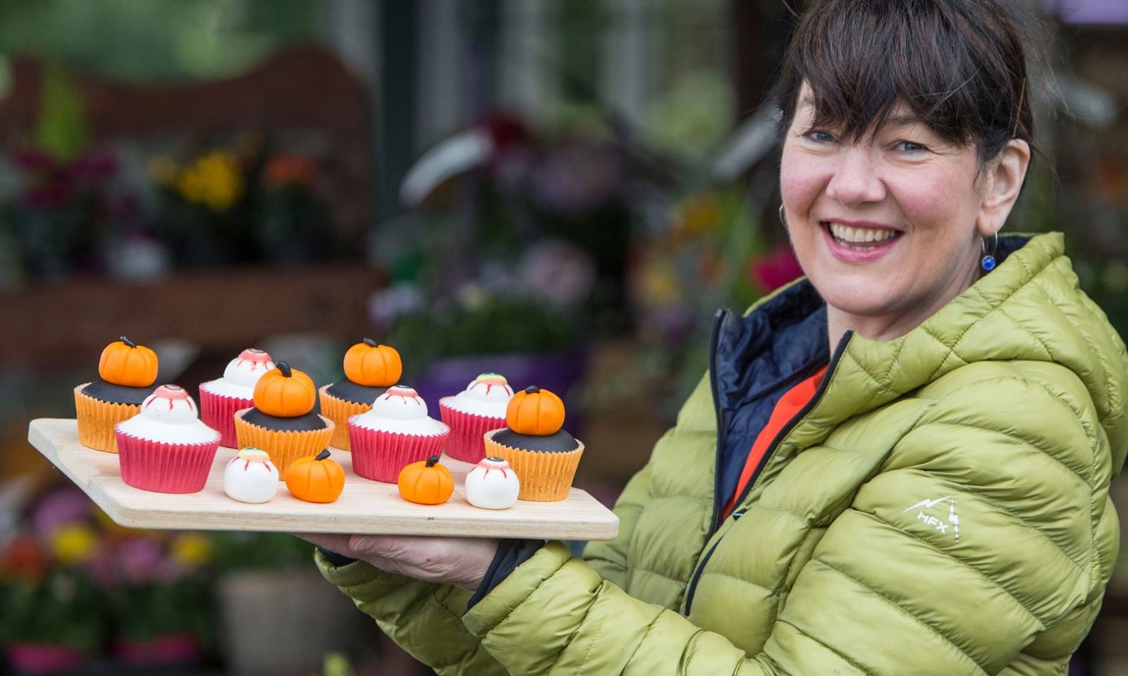Rosie McNeil holding up a tray of her home made cakes