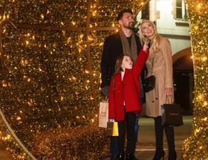 Family looking at Golden Bauble in Lisburn Square