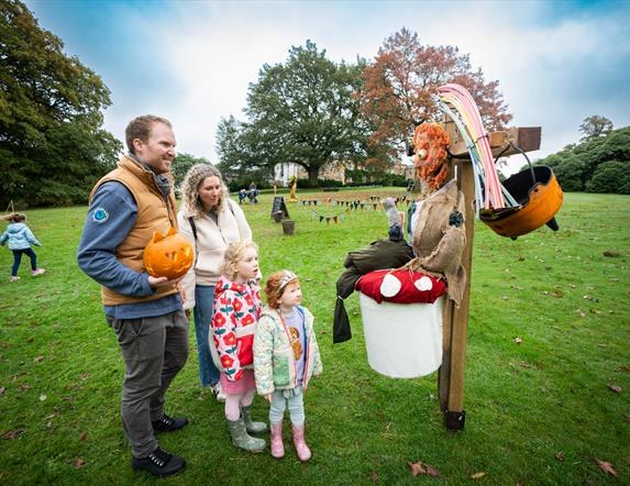 Family looking at scarecrow in grounds of Hillsborough Castle & Gardens