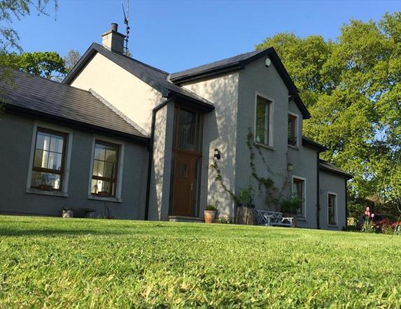 Image shows front entrance of the property with lawn at the front