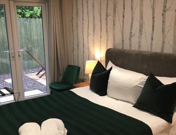 Image is of double bedroom with patio doors onto courtyard outside