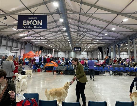 Image is of dogs and owners in the Eikon 
Exhibition Centre dog show
