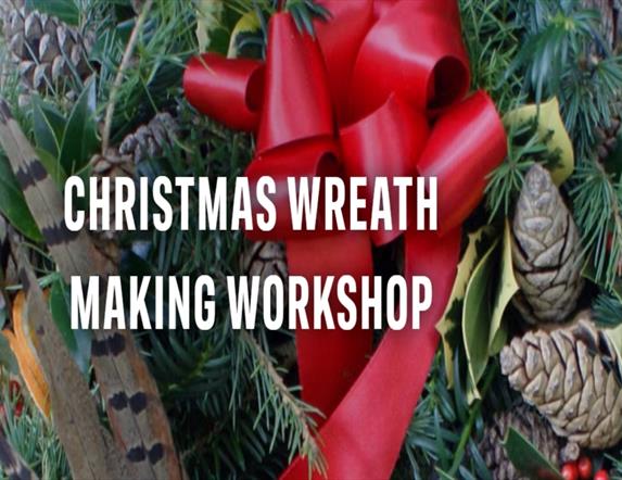 Image shows Christmas Wreath with red ribbon and berries.