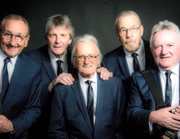 5 men in suits with guitars