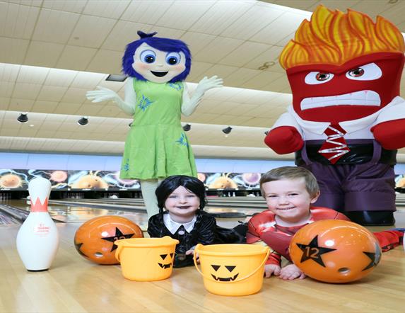 Image shows characters and two children in Halloween Costumes at Dundonald International Ice Bowl