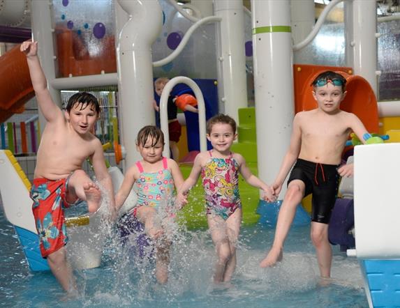 Image shows four children having fun splashing in the LeisurePlex children's pool