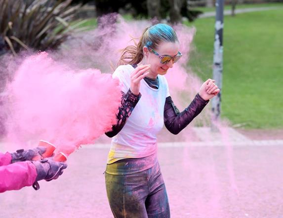 Image is of female taking part in the Mayor's Colour Run in Dundonald