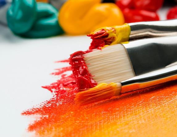 Image shows a variety of paint brush sizes and paint