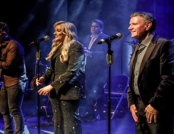 Image is of singers on stage