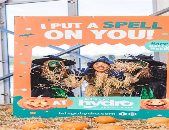 Image is of a scarecrow and two witches