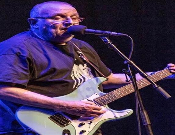 Image is of musician Ronnie Greer playing the guitar