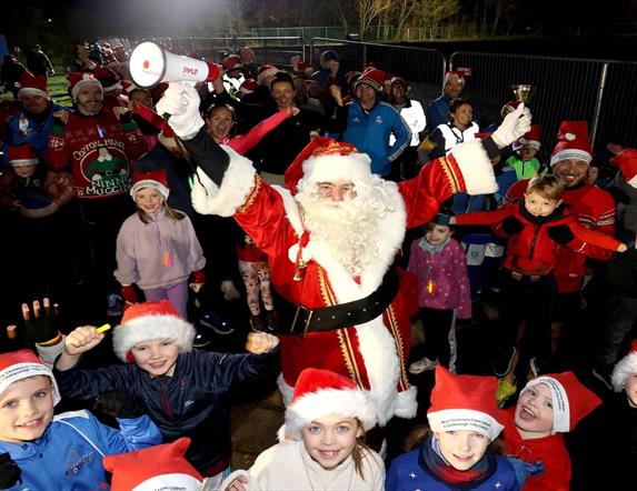 Image is of Santa and participants of the Santa Dash run