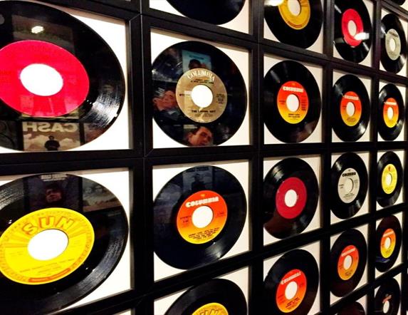 Image is a wall of various vinyl records