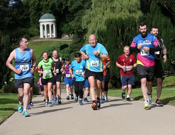 Runners running up the hill with Lady Alice's Temple in the background