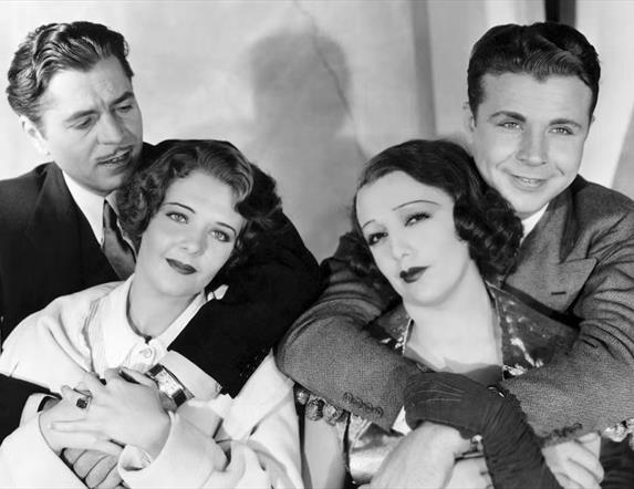 Black and white photo from movie 42nd Street 2 men hugging 2 women