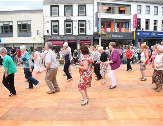Dancers dancing on wooden floor in Market Square, Lisburn