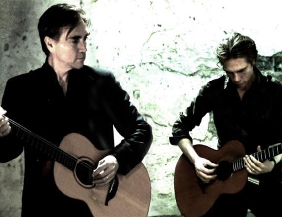 Two men playing guitar