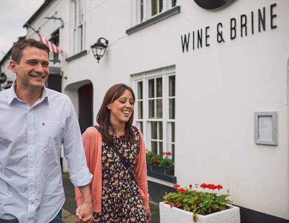 Couple walking outside the Wine & Brine restaurant