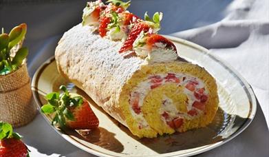 Image is of a strawberry and cake roll