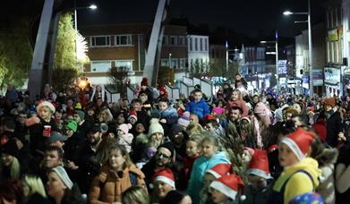 Image is of crowd of people waiting for the Christmas Tree Switch on at Bow Street Lisburn
