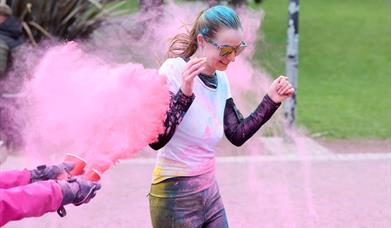 Picture of a running being being colour bombed