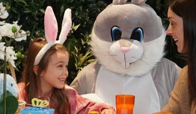 Easter Bunny with little girl and woman.