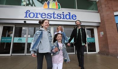 An image of a family leaving the shopping centre at Forestside