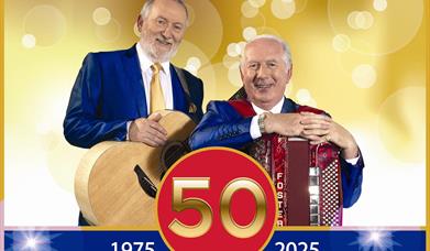 Image is of the singers Foster & Allen with their instruments