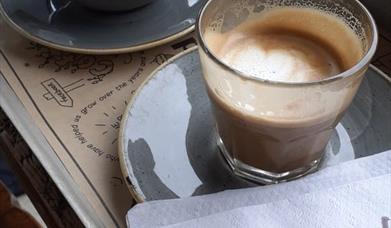 Image is of 2 cups of coffee in Ground Espresso Bar Sprucefield