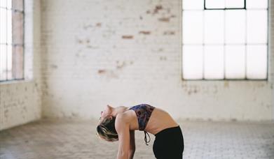 Lady doing yoga on pink mat