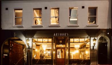 An image of the exterior of Arthur's in the evening
