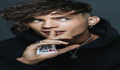 Joel M doing a card trick