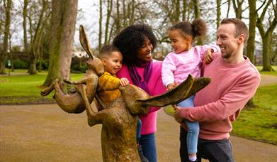 Family at Guess How Much I Love You sculpture in Castle Gardens, Lisburn