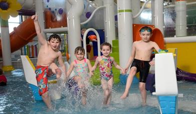 Image shows four children having fun splashing in the LeisurePlex children's pool
