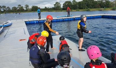 A group of children getting ready to do watersports