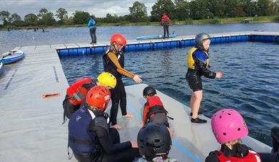 Image is of children preparing to paddle at Moira Lakes