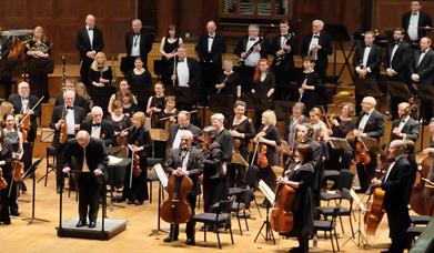 Image is members of the Studio Symphony Orchestra on stage