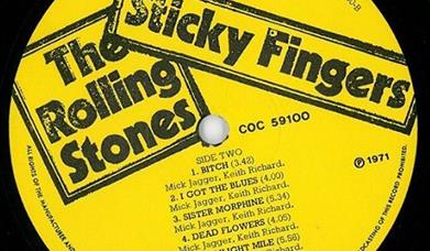 Yell0ow LP with the Rolling Stones & Sticky Fingers written on it