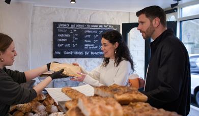Couple at counter in Roundhouse Bakery