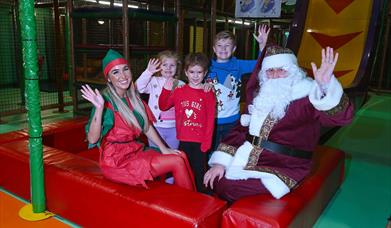 Picture of Children in soft play area beside Santa Claus and elf
