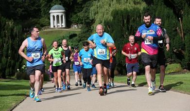 Runners running up the hill with Lady Alice's Temple in the background