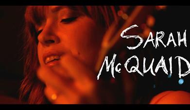 Image is of the singer Sarah McQuaid