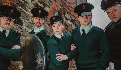 Image shows 4 people dressed in police uniform.