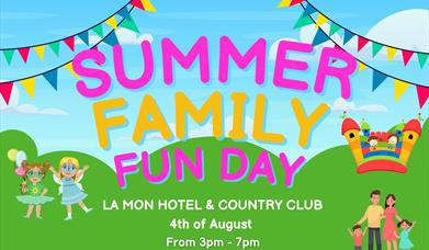 Image is of the Summer Family Fun Day at La Mon Hotel showing rainbow flags, a bouncy castle and cartoon people