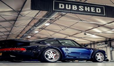Dark Blue Car with Dubshed sign above it