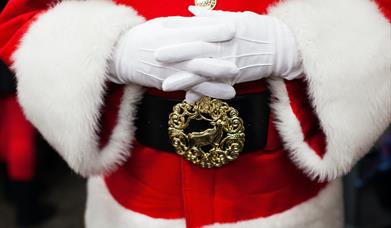 An image of Santa with his hands crossed over his stomach